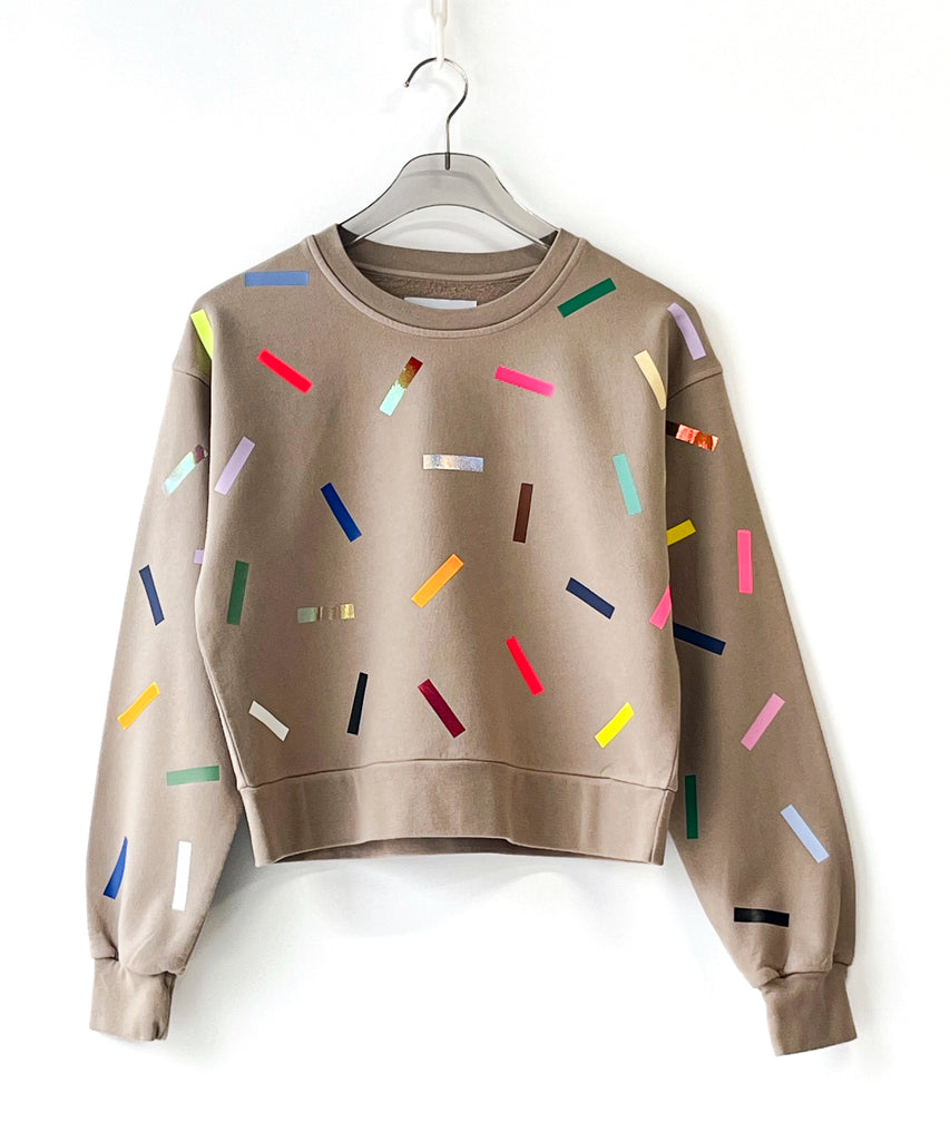 a 100% cotton sweatshirt with colorful sprinkles pattern in beige