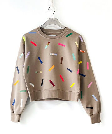 a 100% cotton sweatshirt with colorful sprinkles pattern in beige