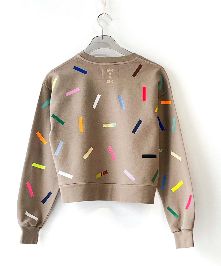 a 100% cotton sweatshirt with colorful sprinkles pattern in beige