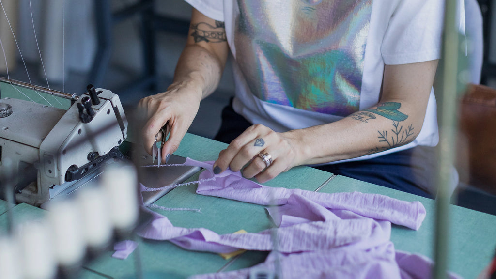 Person working with fabric on a sewing machine in Toronto Okayok Studio