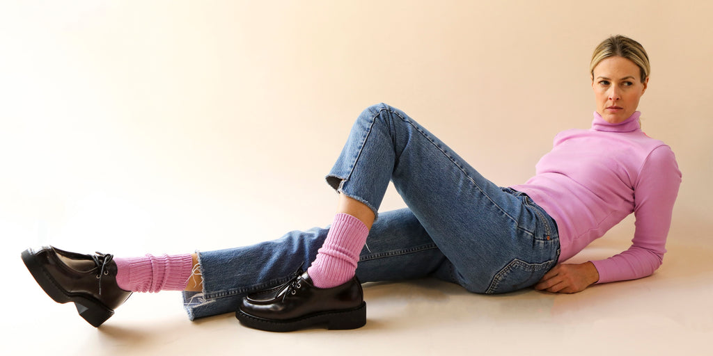 Woman wearing a cotton turtleneck tshirt with matching cotton socks in pink