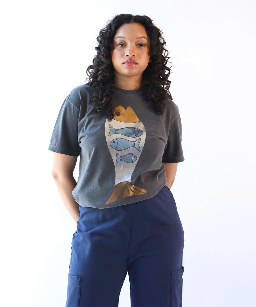 woman wearing a dark gray cotton t-shirt with abundant fish graphic