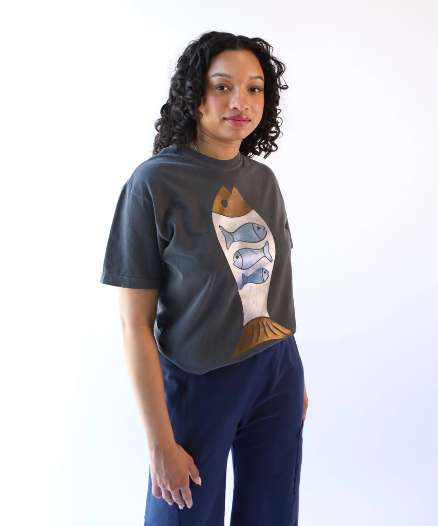 woman wearing a dark gray cotton t-shirt with abundant fish graphic