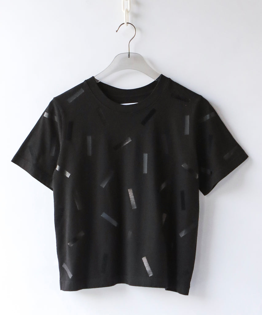 a boxy cotton tshirt in black with black confetti sprinkle graphic print
