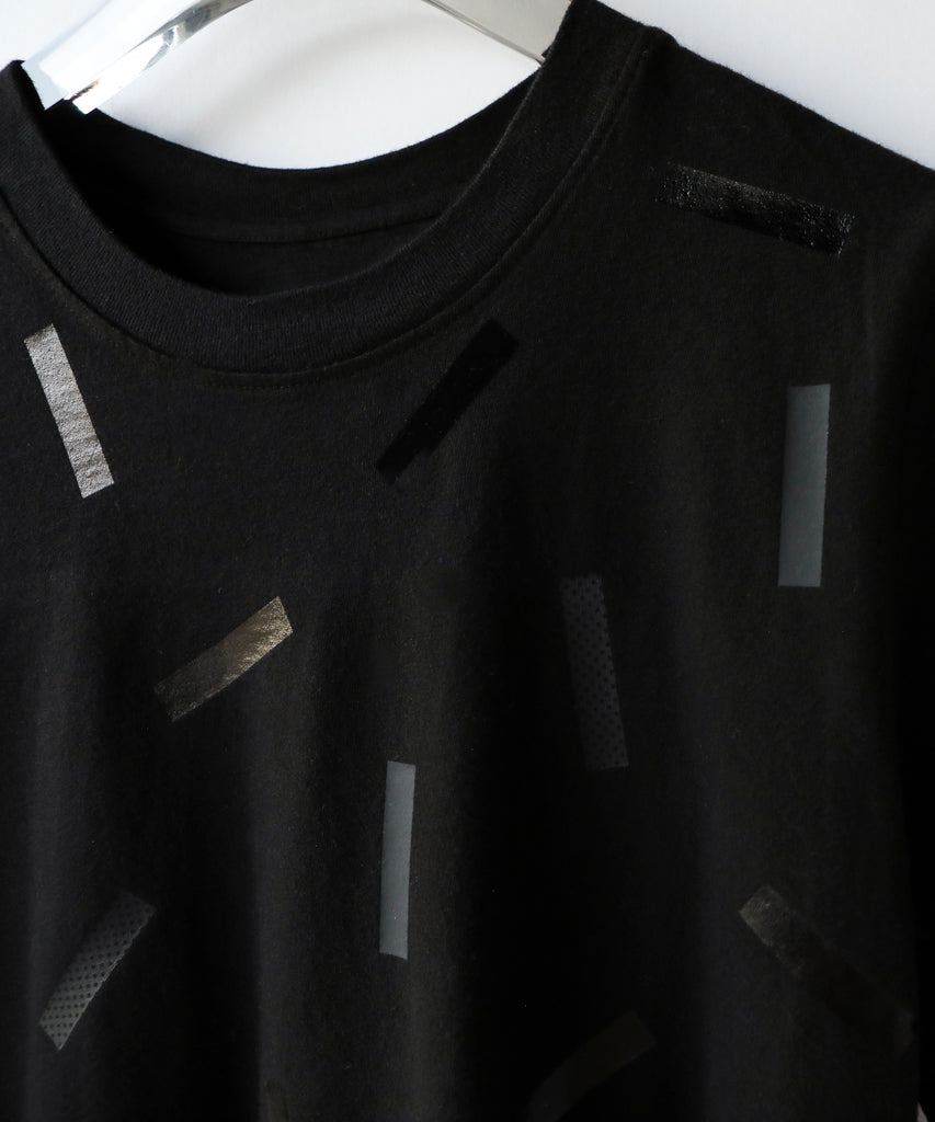 a boxy cotton tshirt in black with black confetti sprinkle graphic print