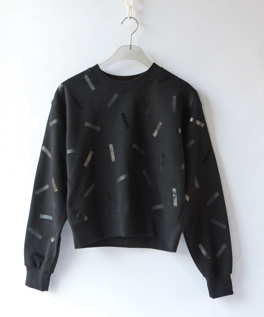 a cotton sweatshirt in black with black confetti sprinkle graphic print