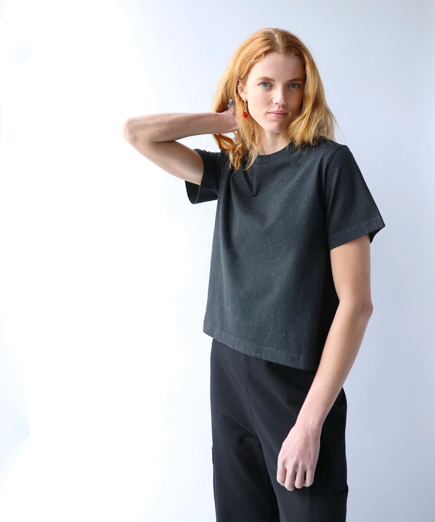 woman wearing a black cotton tshirt in boxy cropped cut