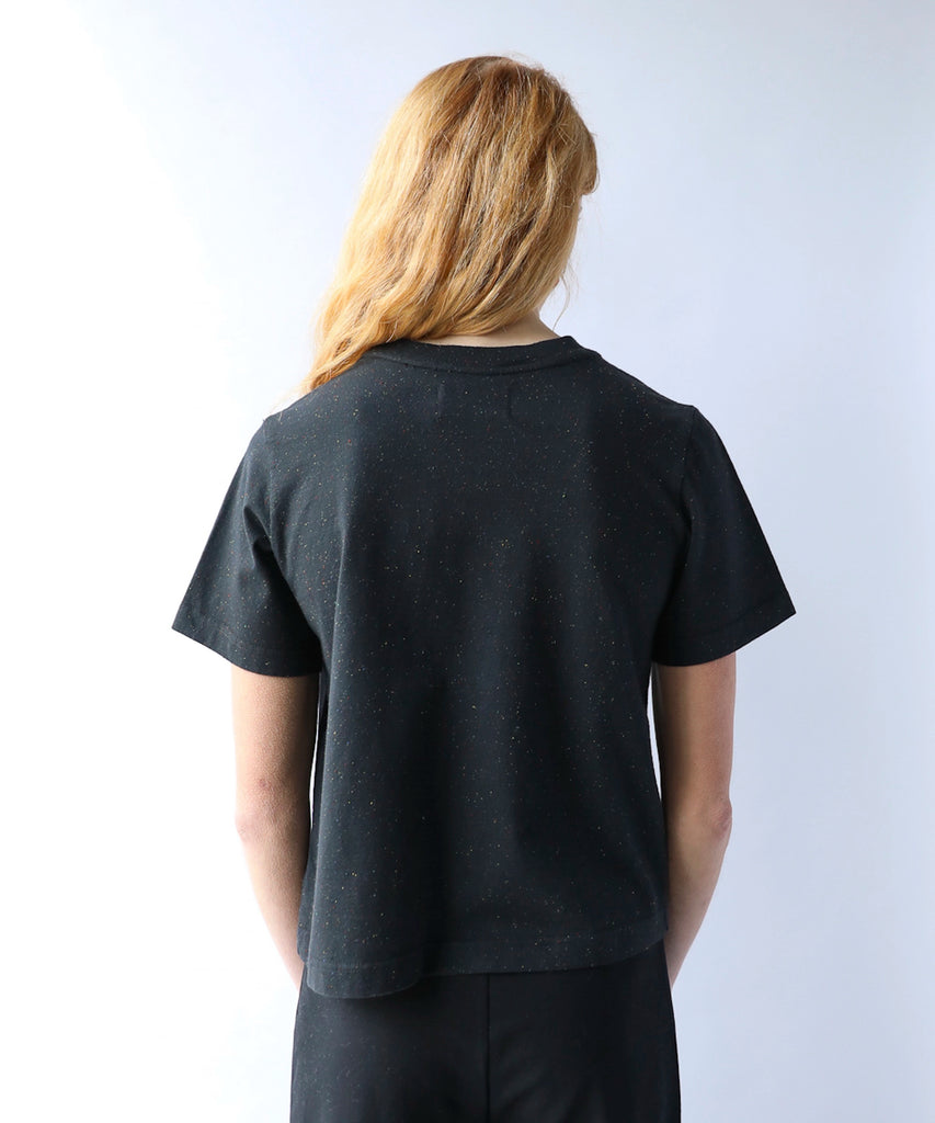 woman wearing a black cotton tshirt in boxy cropped cut