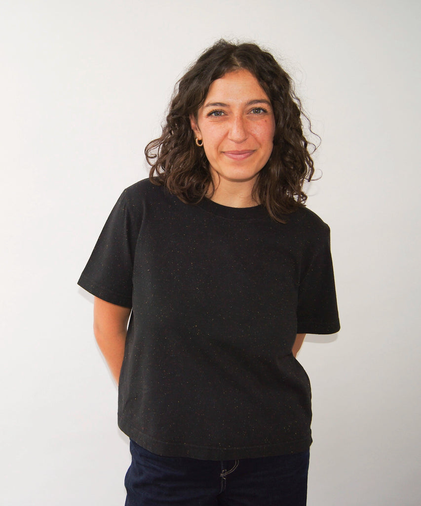 woman wearing a black cotton tshirt in boxy cropped cut