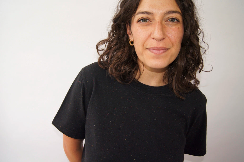 woman wearing a black cotton tshirt in boxy cropped cut