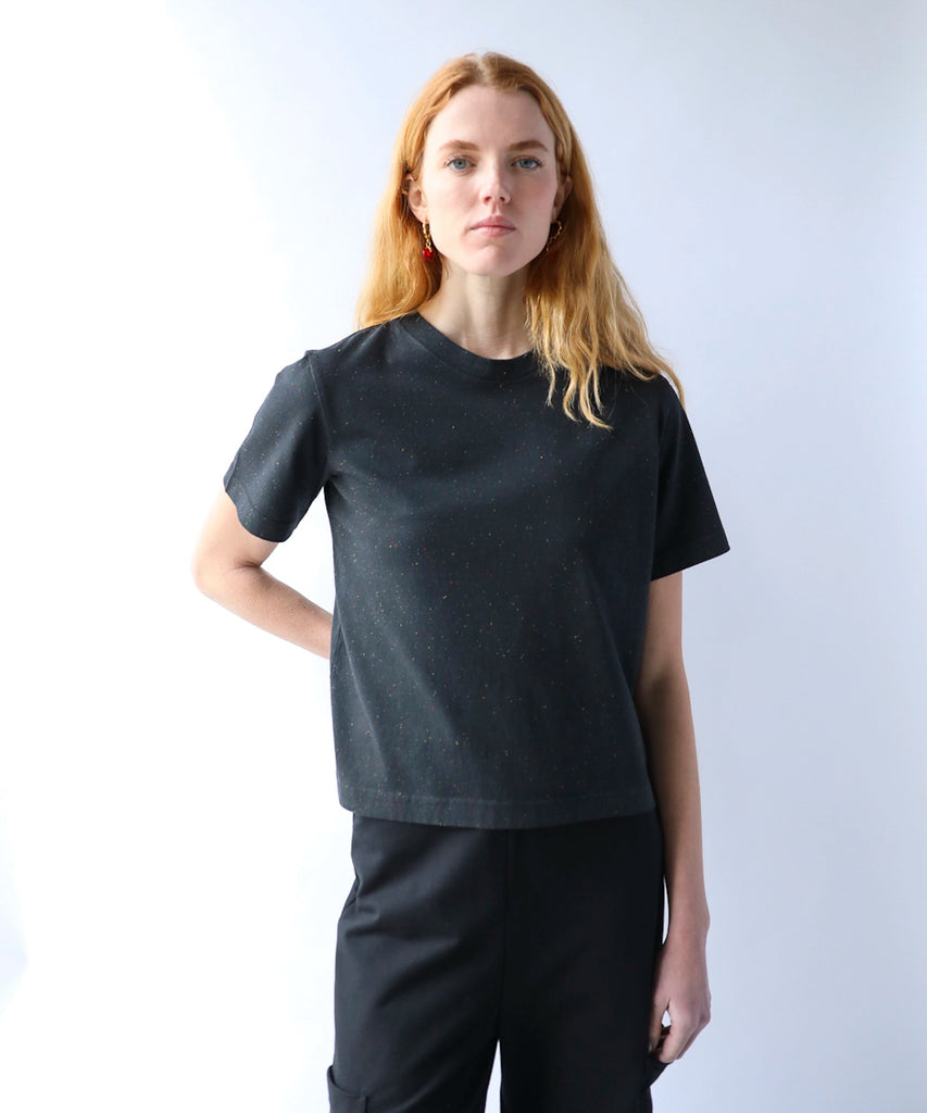 woman wearing a black cotton tshirt in boxy cropped cut