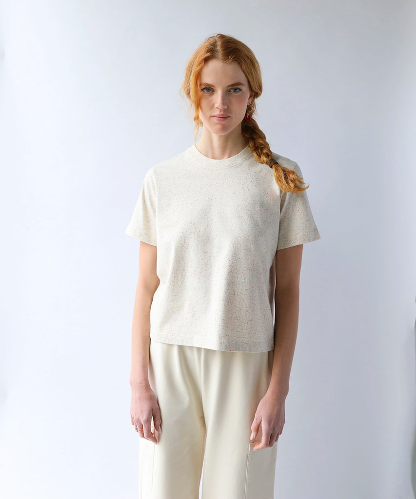 woman wearing a natural beige cotton tshirt in boxy cropped cut