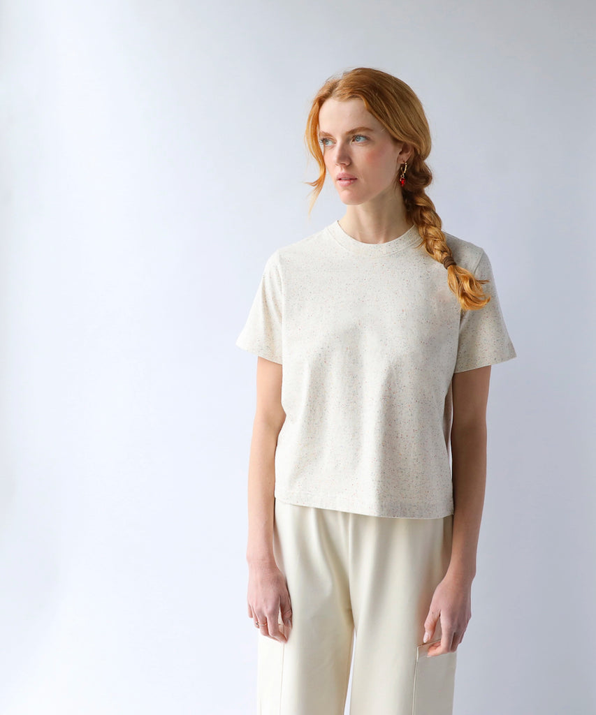 woman wearing a natural beige cotton tshirt in boxy cropped cut