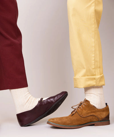 A pair of unisex, lightweight cable dressy cotton socks in pale yellow and cream made in Canada by Toronto brand OkayOk