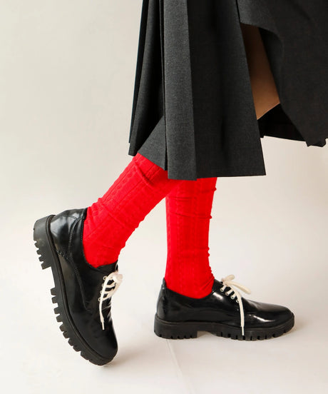 A pair of unisex, lightweight cable dressy cotton knee high socks in bright red with dark red made in Canada by Toronto brand OkayOk 