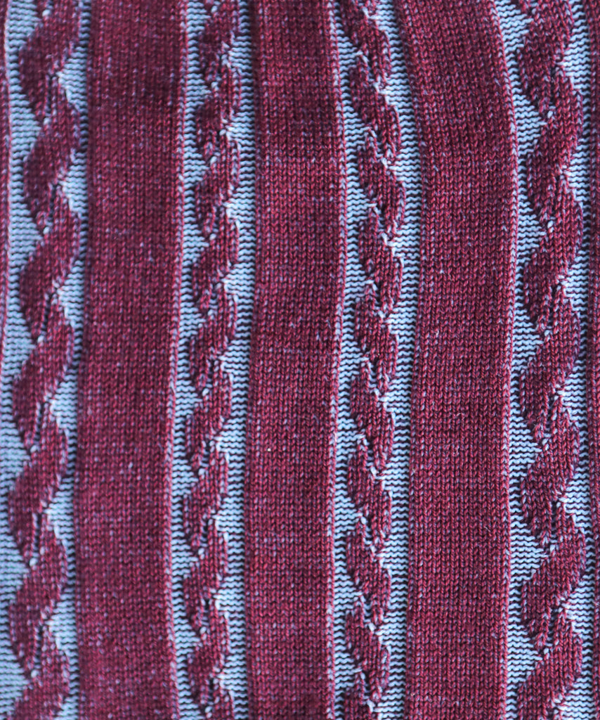 Close-up of a textured fabric with braided pattern in red and blue.
