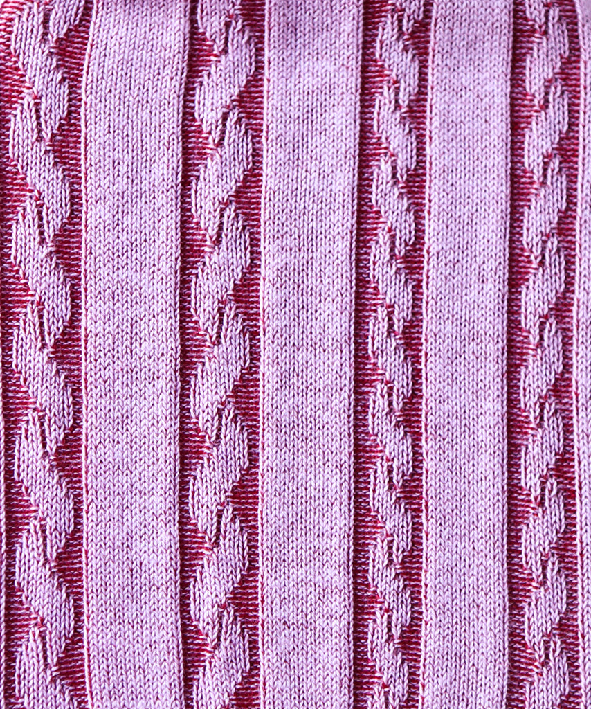 Close-up of a textured fabric with a cable knit pattern in purple on a light gray background