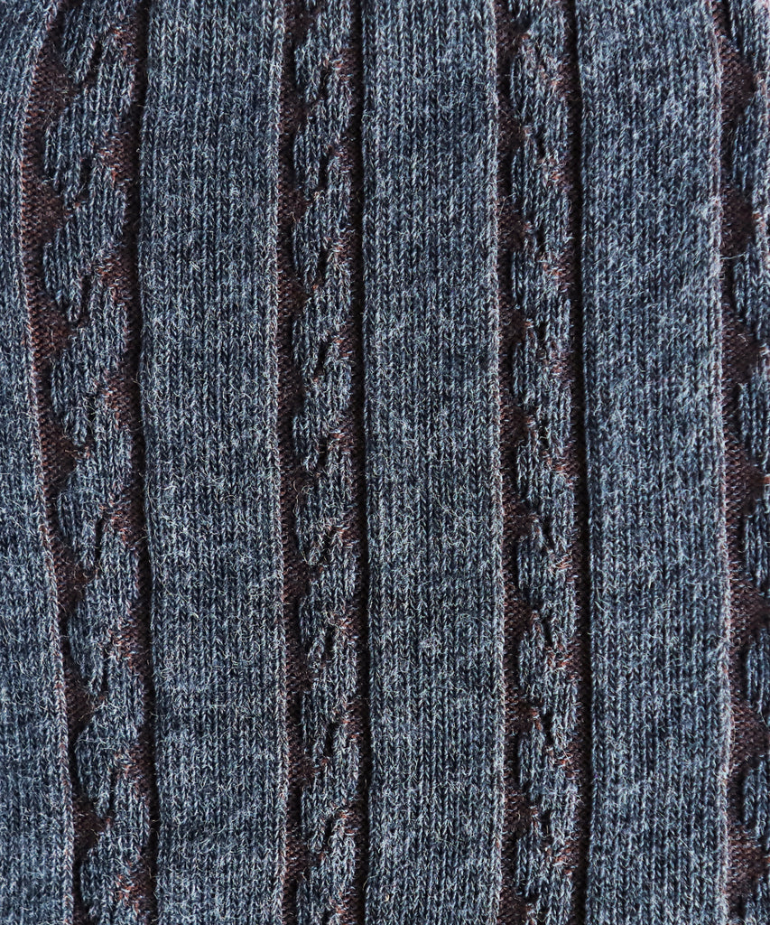 Close-up of textured blue fabric with cable knit pattern