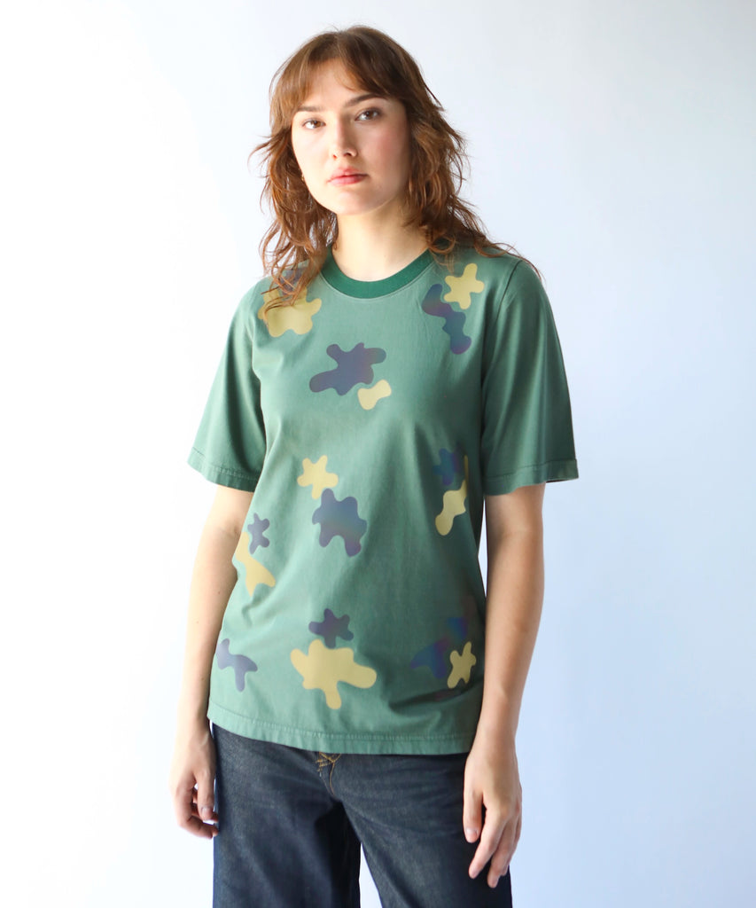 woman wearing a green reflective camouflage patterned cotton tshirt