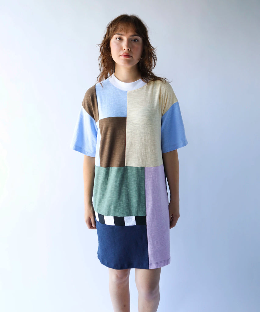Woman wearing a colorful patchwork quilted tshirt dress in soft colours