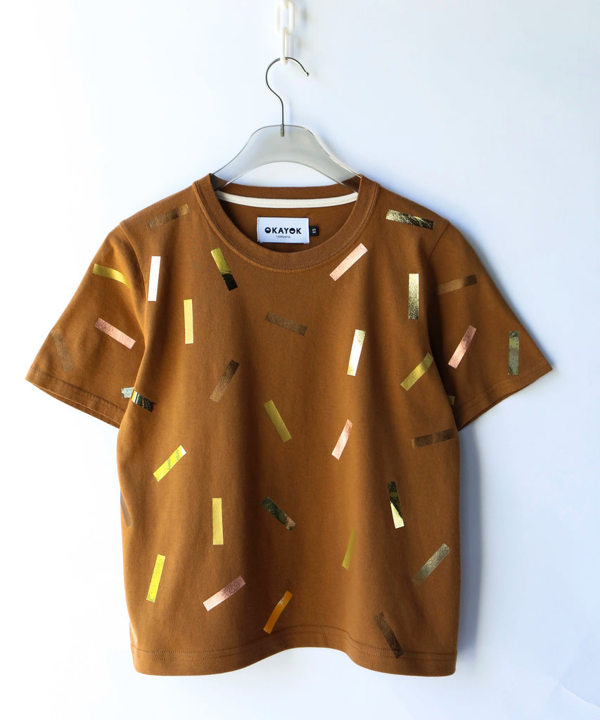 a boxy cotton tshirt in tobacco brown with gold confetti sprinkle graphic print