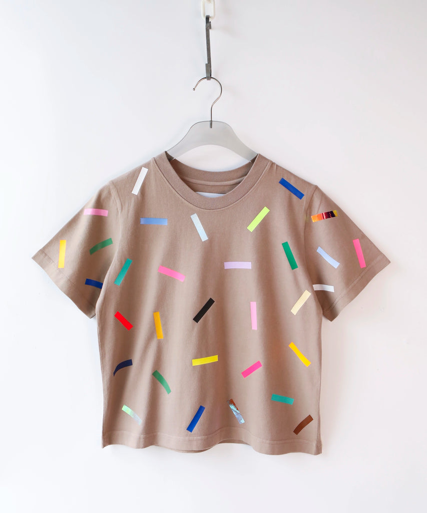 a taupe cotton t-shirt with colorful confetti sprinkles pattern in beige