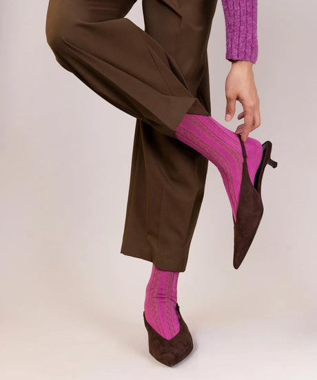 A pair of unisex, lightweight cable dressy cotton socks in fuschia pink and olive green made in Canada by Toronto brand OkayOk styled with pointed kitten toe heels