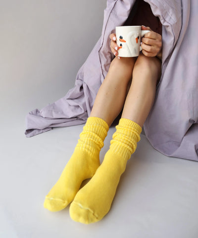 A pair of unisex ribbed crew cotton socks in bright yellow made in Canada by Toronto brand OkayOk