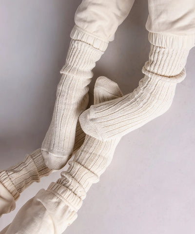 two pairs of feet in thick cotton socks in beige made in Canada by Toronto brand Okayok