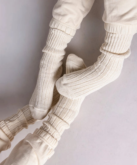 two pairs of feet in thick cotton socks in beige made in Canada by Toronto brand Okayok