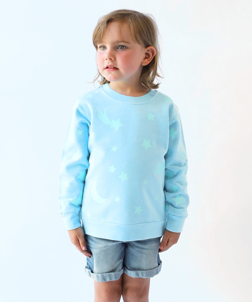 child wearing glow in the dark star printed cotton sweatshirt in light blue