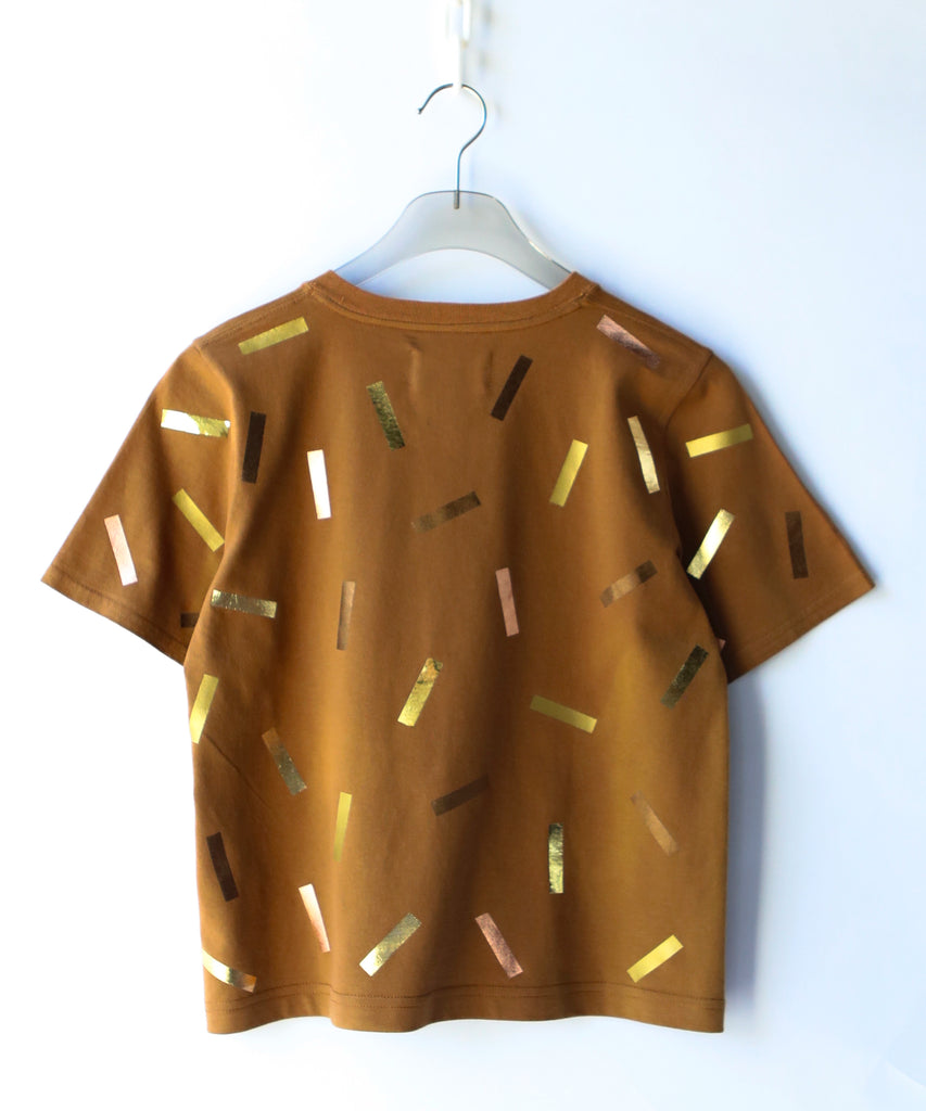 a boxy cotton tshirt in tobacco brown with gold confetti sprinkle graphic print