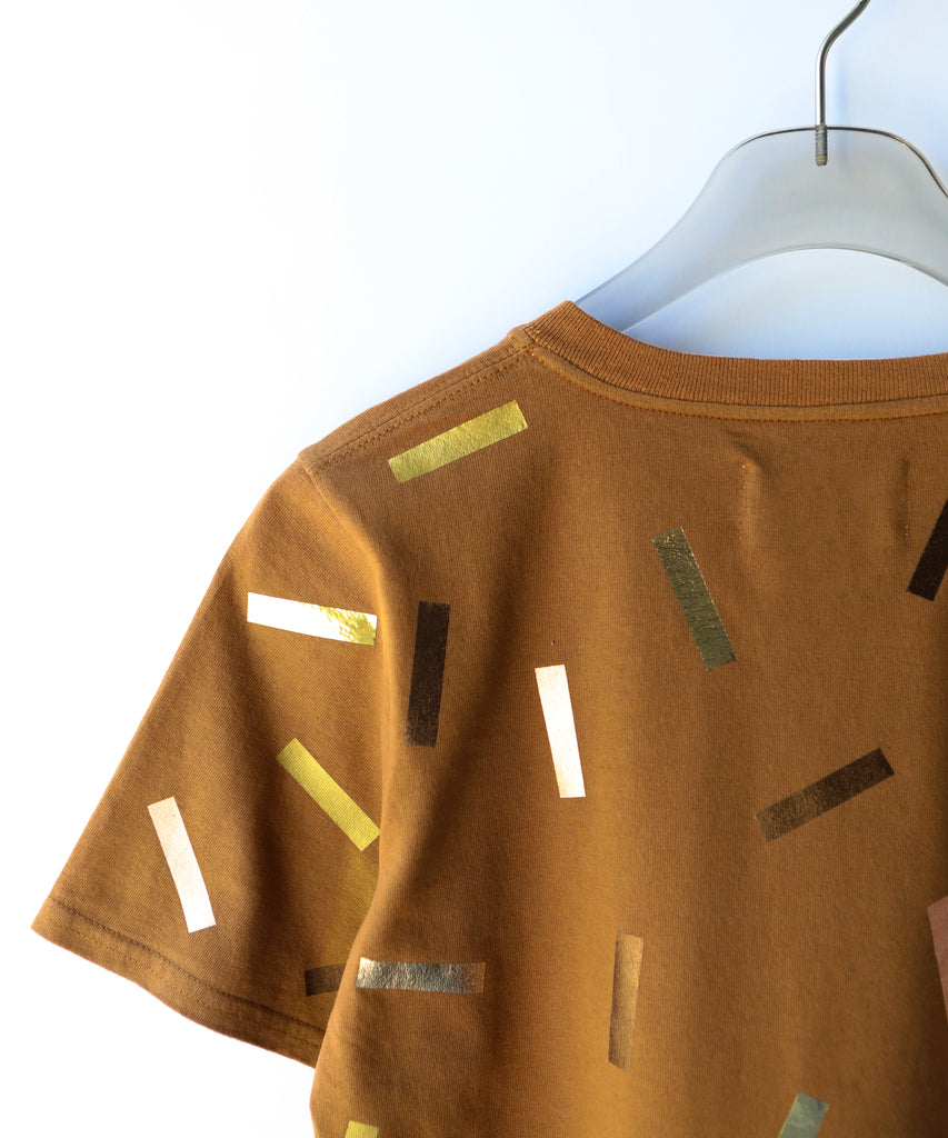 a boxy cotton tshirt in tobacco brown with gold confetti sprinkle graphic print