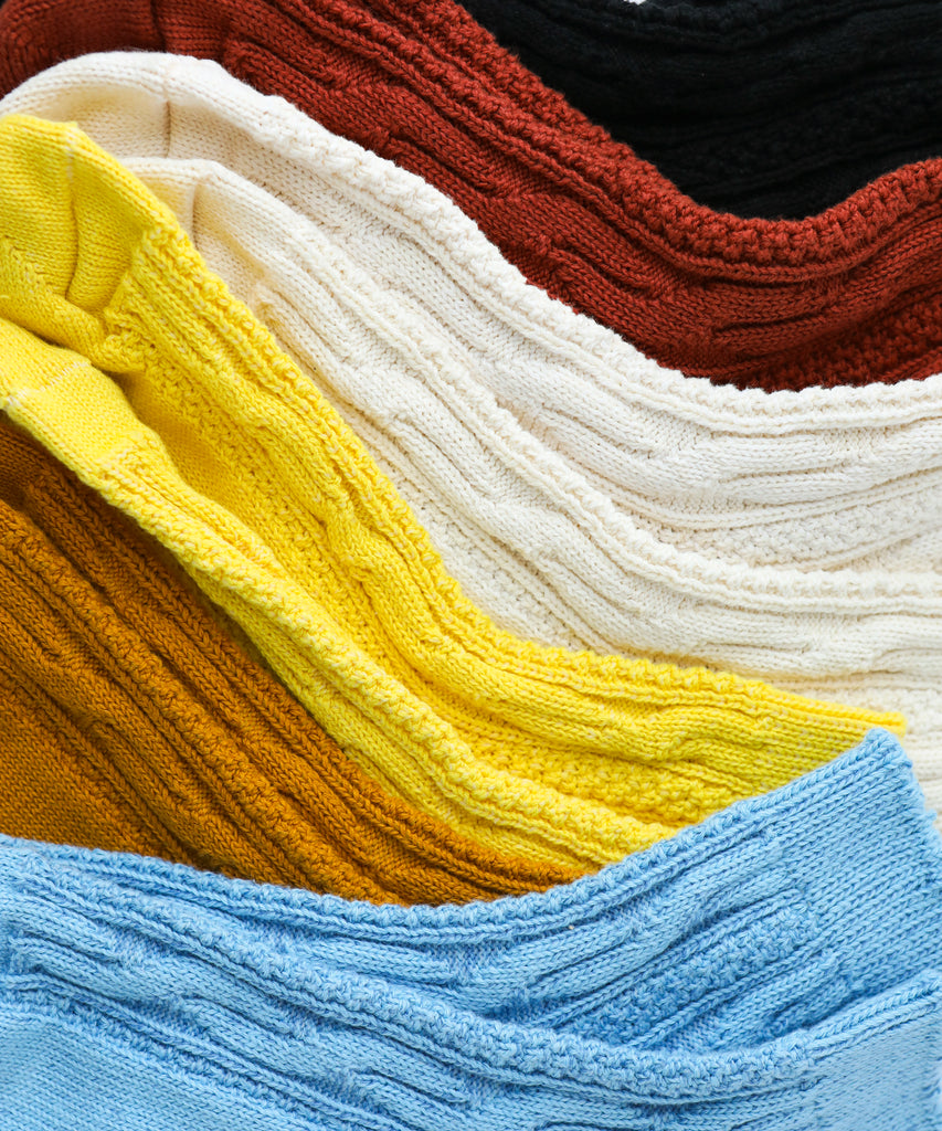 Stack of colorful cotton knitted socks  in various colors including yellow, blue, red, and white