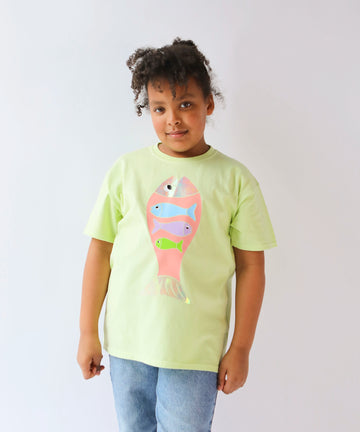 Child wearing a light green cotton t-shirt with a colorful fish design in pastel colours