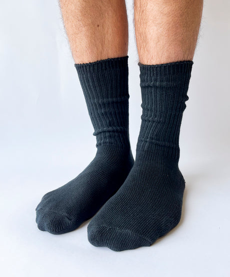 A pair of unisex ribbed crew cotton socks in black made in Canada by Toronto brand OkayOk