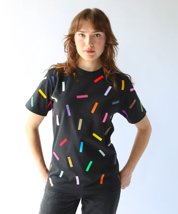 Woman wearing a black cotton t-shirt with colorful confetti sprinkles on it