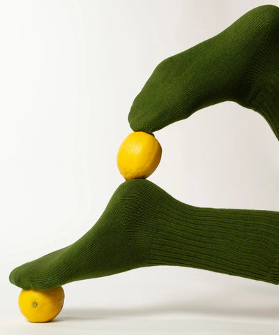 A pair of unisex ribbed crew cotton socks in moss green made in Canada by Toronto brand OkayOk