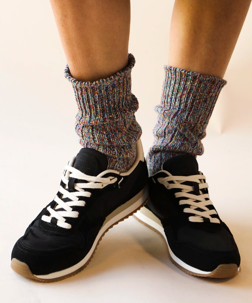 person wearing a pair of thick cotton knitted socks in multicolour