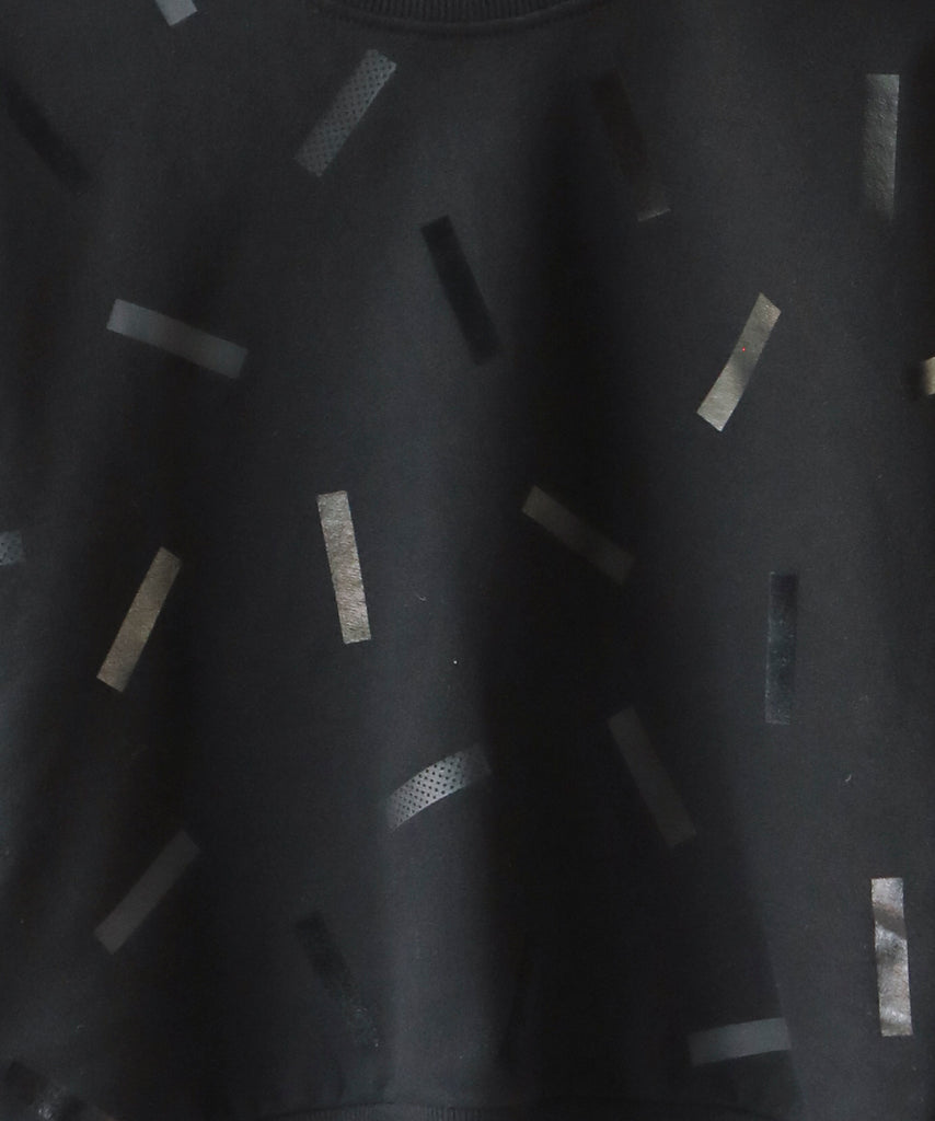 swatch of black with black confetti sprinkle graphic print