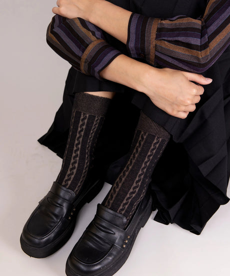 A pair of unisex, lightweight cable dressy cotton socks in black and taupe made in Canada by Toronto brand OkayOk styled with loafers