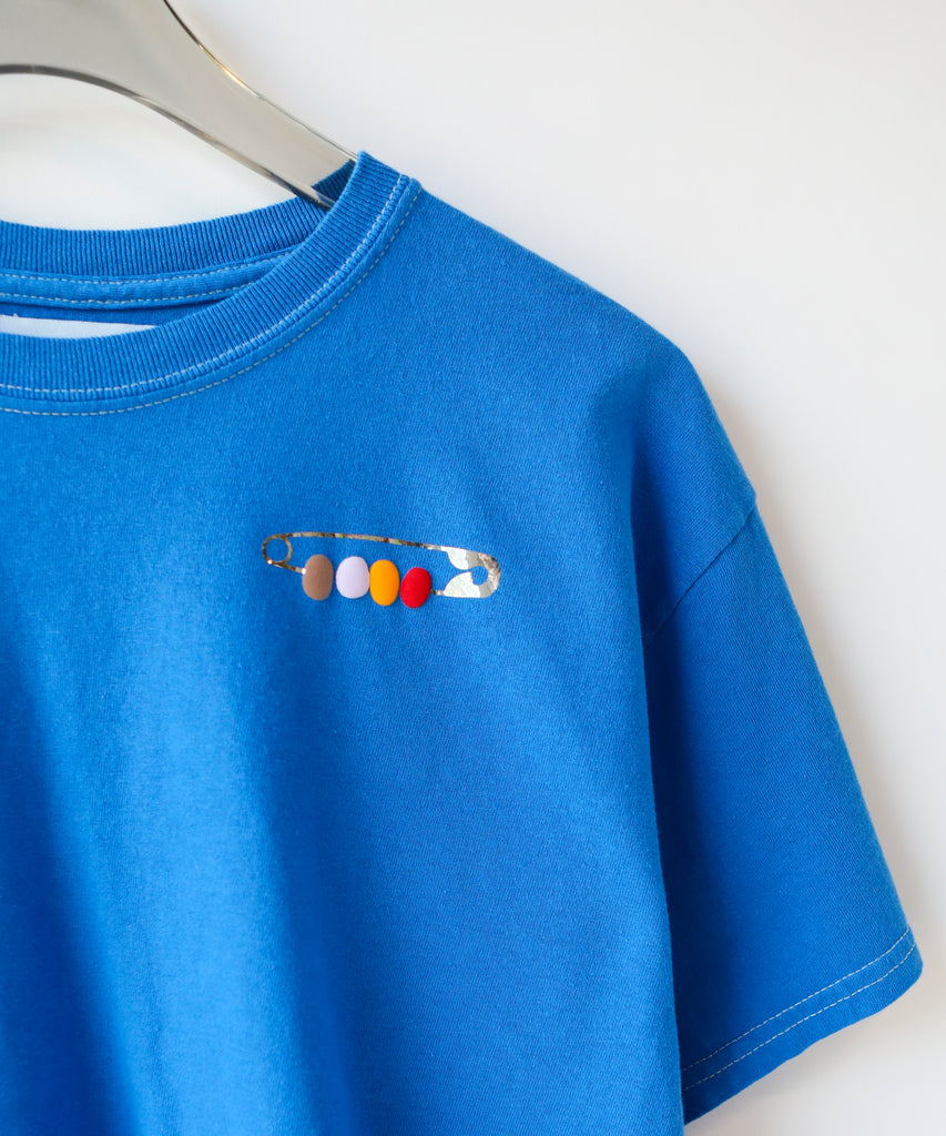 a blue cotton t-shirt with a friendship pin graphic on it - safety pin with beads