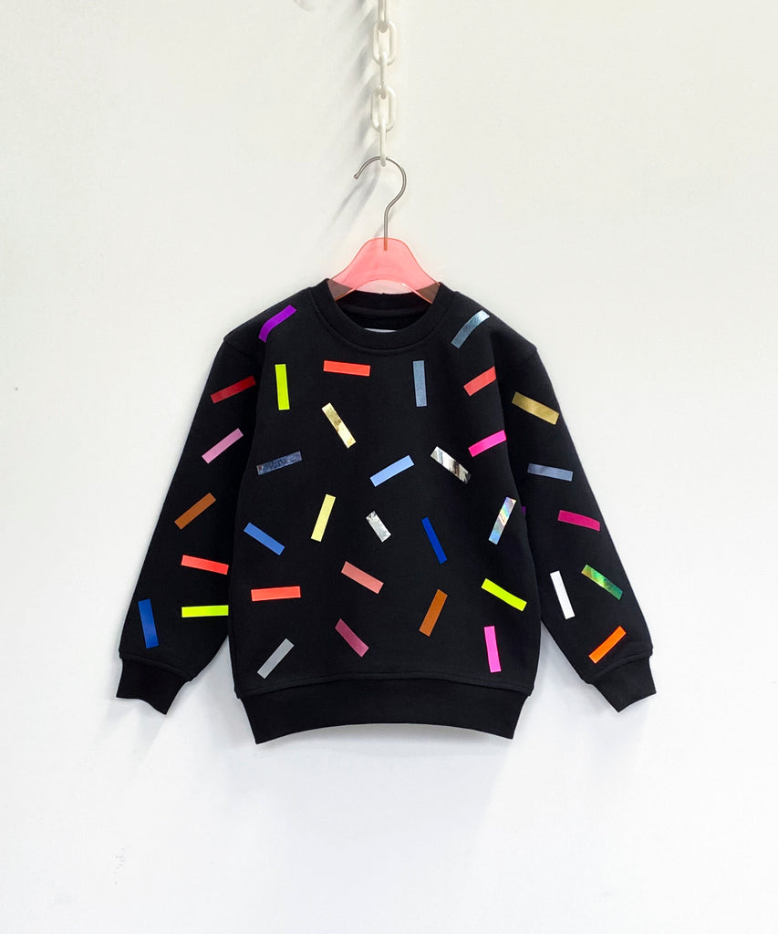 a cotton sweatshirt in black with colourful confetti sprinkle pattern 